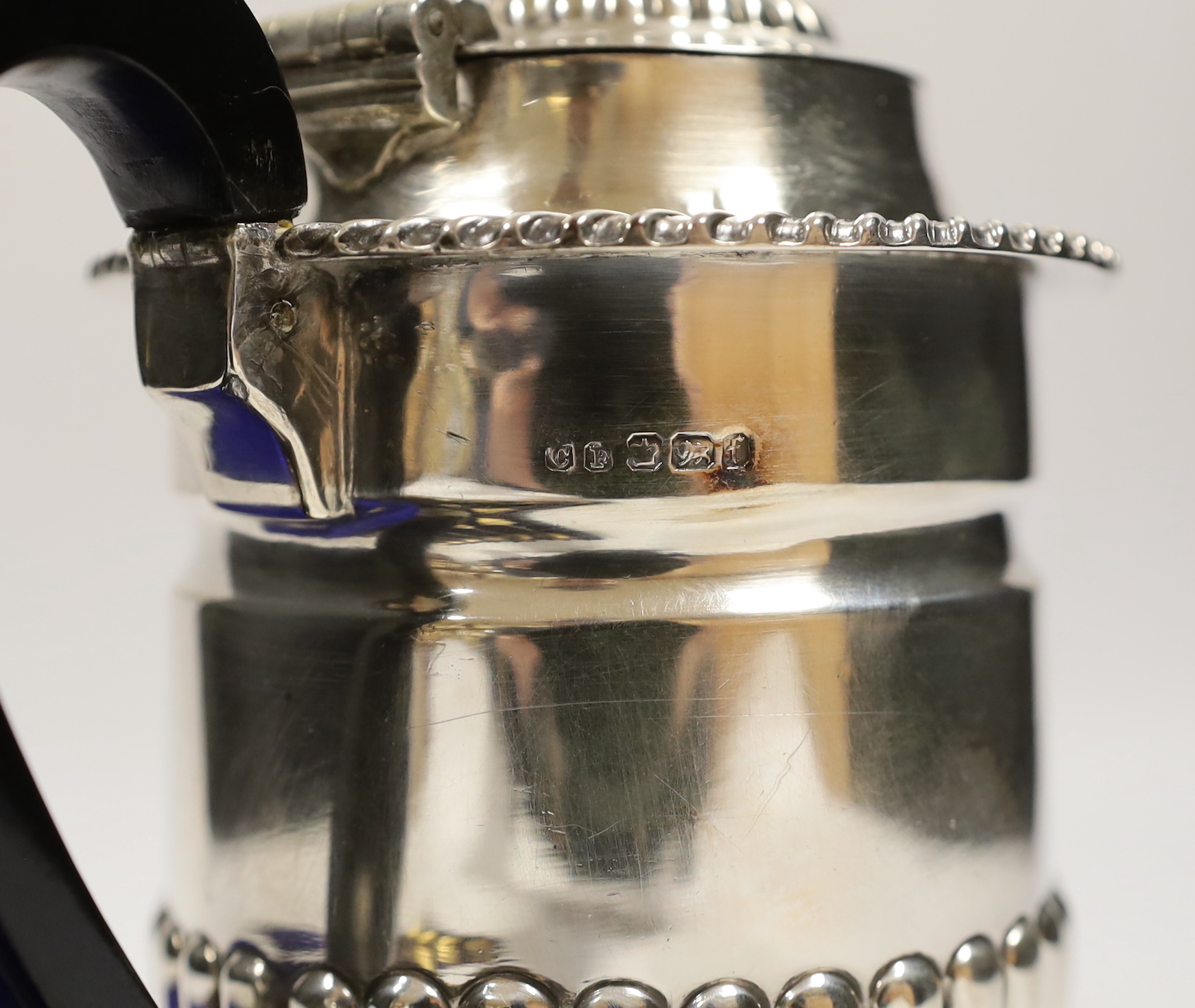 A late Victorian demi fluted silver hot water pot, Charles Favell & Co, Sheffield, 1898, gross weight 11.8oz and a cased set of six silver gilt teaspoons with throne terminals.